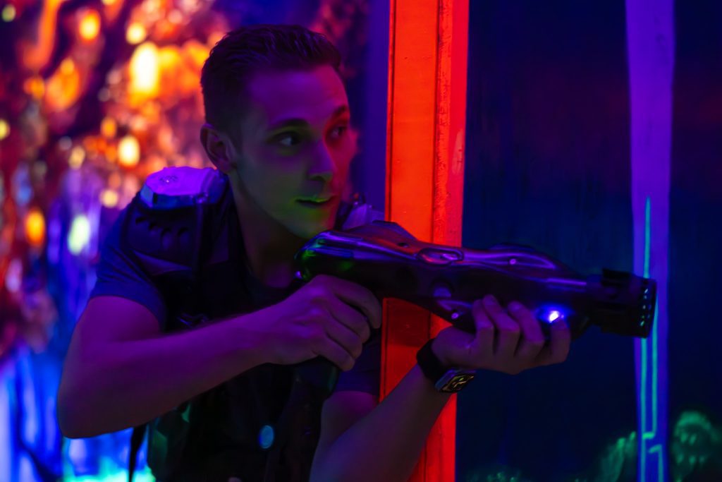 image of young man playing laser tag